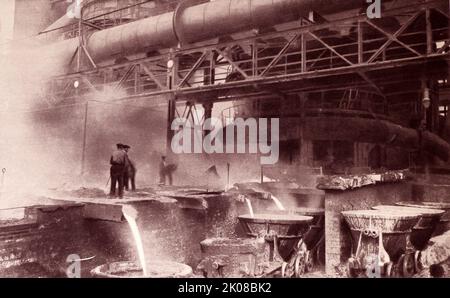 Smelting iron ore in the blast furnaces at Middlesborough, England in the early 20th century. Black and white photograph Stock Photo