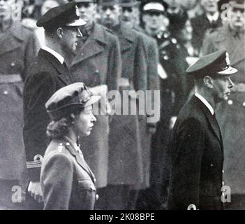 Princess Elizabeth stands with her father, King George VI, and fiance Prince Philip, Duke of Edinburgh, at the Cenotaph service, 1947. Elizabeth II (Elizabeth Alexandra Mary; born 21 April 1926) is Queen of the United Kingdom and 14 other Commonwealth realms Stock Photo