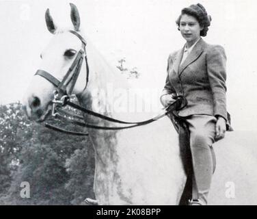 Princess Elizabeth on her horse. Elizabeth II (Elizabeth Alexandra Mary; born 21 April 1926) is Queen of the United Kingdom and 14 other Commonwealth realms Stock Photo