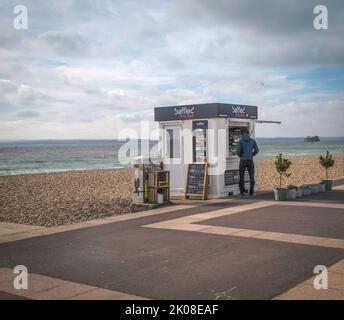 Seaside beach kiosk with customer at the hatch. Stock Photo