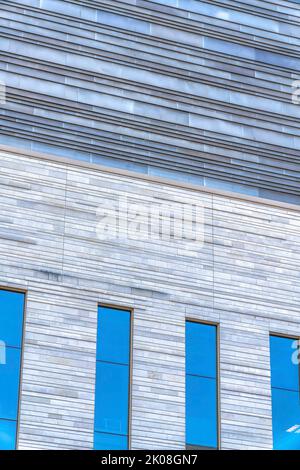 Exterior of a building with geometric pattern on wall and glass windows. City views in downtown Austin Texas featuring housing or building architectur Stock Photo
