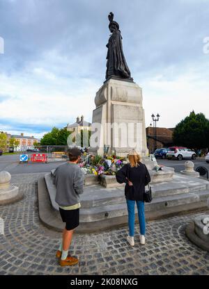Poundbury, Dorset, UK.  10th September 2022.  Floral tributes to the late HM Queen Elizabeth II have been laid by mourners at the base of the statue of the Queen Mother at Queen Mother Square at Poundbury in Dorset.  The statue was unveiled by the Queen in 2016.  Picture Credit: Graham Hunt/Alamy Live News Stock Photo