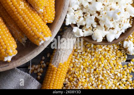 Harvesting popcorn from the cob with a bowl of popped corn surrounded