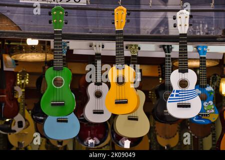 Collection of ukuleles hanging in a music store in Athens Stock Photo