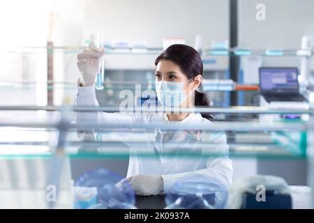 Chinese scientist examining medical sample in laboratory Stock Photo