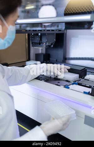 Chinese female researcher working in laboratory Stock Photo