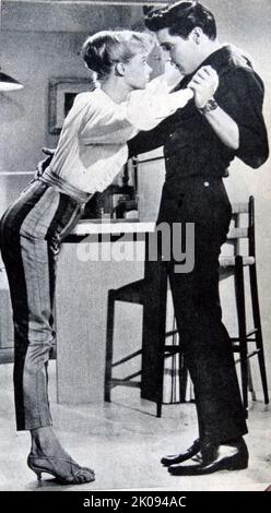 Newspaper review of Girls! Girls! Girls! 1962 film featuring Elvis Presley. Photograph of Elvis Presley with Laurel Goodwin. Stock Photo