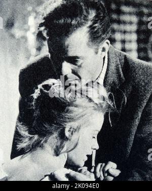 Newspaper review of the The Mind Benders, a 1963 British thriller film, photograph of Dirk Bogarde and Mary Ure. Stock Photo