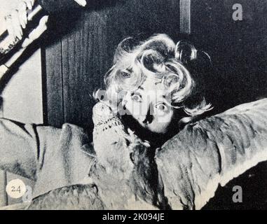 Newspaper cutting photograph of Tippi Hedren in the The Birds. The Birds is a 1963 American natural horror-thriller film produced and directed by Alfred Hitchcock Stock Photo