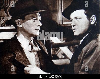 Joseph Cotten and Orson Welles in The Third Man, a 1949 British film noir directed by Carol Reed. Joseph Cheshire Cotten Jr. (May 15, 1905 - February 6, 1994) was an American film, stage, radio and television actor. George Orson Welles (May 6, 1915 - October 10, 1985) was an American director, actor, screenwriter, and producer who is remembered for his innovative work in radio, theatre and film. Stock Photo