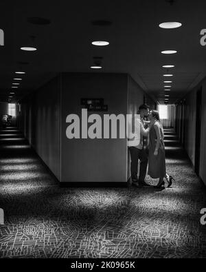 Couple in love standing and kissing in the corridor of the hotel Stock Photo
