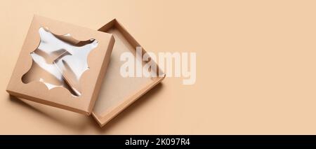 Open cardboard box on beige background with space for text Stock Photo
