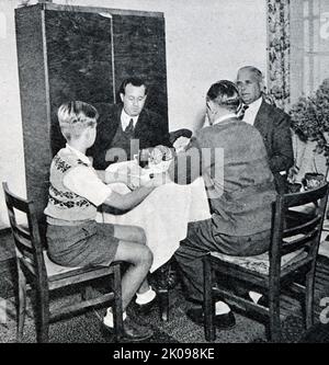 Refugee family in their home at the former Dachau Concentration Camp. Refugees in the former concentration camp Dachau. Dachau was a Nazi concentration camp opened on 22 March 1933, which was initially intended to hold political prisoners. It is located northwest of Munich in the state of Bavaria, in southern Germany. In the postwar years, the Dachau facility served to hold SS soldiers awaiting trial. After 1948, it held ethnic Germans who had been expelled from eastern Europe and were awaiting resettlement, and also was used for a time as a United States military base during the occupation. I Stock Photo
