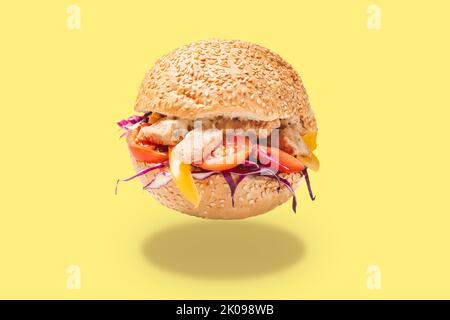 Tasty doner kebab in bun on yellow background Stock Photo