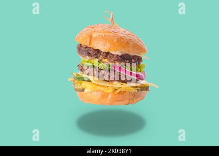Tasty fresh burger on turquoise background Stock Photo