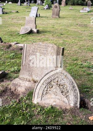 Broken gravestones in St Cuthbert's churchyard in New Herrington, Sunderland, England, UK Stock Photo