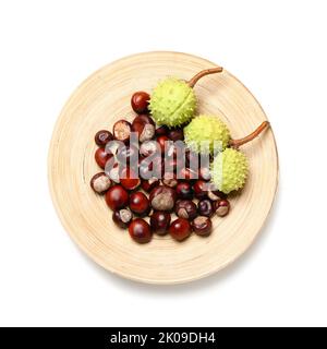 Plate with chestnuts on white background Stock Photo