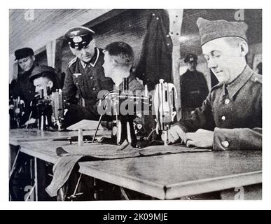 Prisoners making gloves in a German prisoner of war camp during World War II. Stock Photo