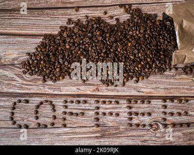 The word coffee made from coffee beans on wooden background Stock Photo