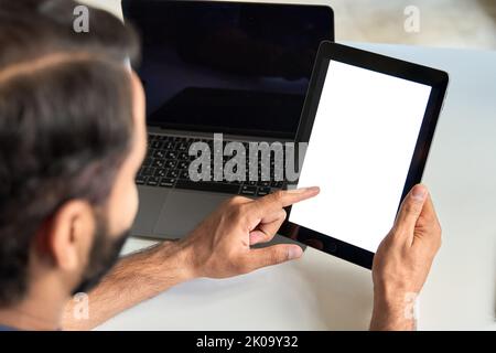 Business man using digital tablet with white screen mock up template at work. Stock Photo