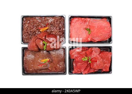 Top View of Assorted Raw Beef Steaks, Liver, and Thighs in Trays Isolated on White Background Stock Photo