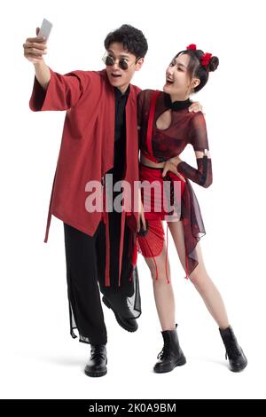 Cheerful young Chinese couple taking selfie with smart phone Stock Photo