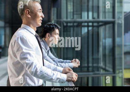 Confident Chinese businessmen looking at view Stock Photo