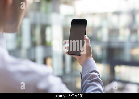 Young Chinese businessman using smart phone Stock Photo