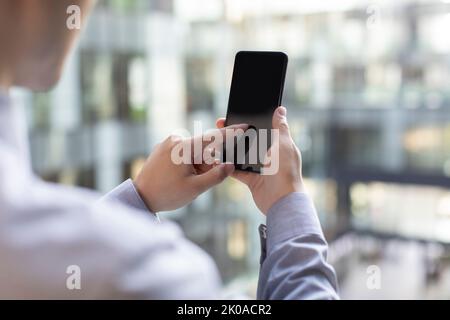 Young Chinese businessman using smart phone Stock Photo