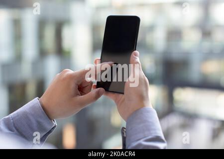 Young Chinese businessman using smart phone Stock Photo