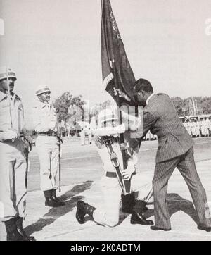 President Ziaur Rahman presenting the Bangladesh flag to an airforce honour guard, 1976 Stock Photo