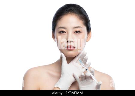 Young Chinese woman receiving Botox treatment Stock Photo