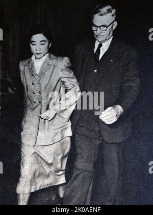 Tokyo Rose leaving the court room, after the verdict, accompanied by U.S. Marshal Herbert C. Cole. Tokyo Rose was a name given by Allied troops in the South Pacific during World War II to all female English-speaking radio broadcasters of Japanese propaganda. Several female broadcasters operated using different aliases and in different cities throughout the territories occupied by the Japanese Empire, including Tokyo, Manila, and Shanghai. Tokyo Rose ceased to be merely a symbol during September 1945 when Iva Toguri D'Aquino was accused of being the 'real' Tokyo Rose, arrested, tried, and becam Stock Photo