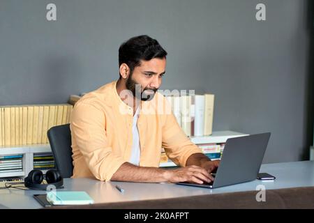 Indian business man professional manager using laptop computer in office. Stock Photo