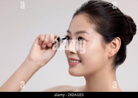 Studio shot of beautiful young Chinese woman Stock Photo