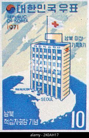 South Korean stamp showing a Red Cross hospital across the dividing border between North and South Korea. It says : '???? ???? (Finding families torn apart by North-South divide)' Stock Photo