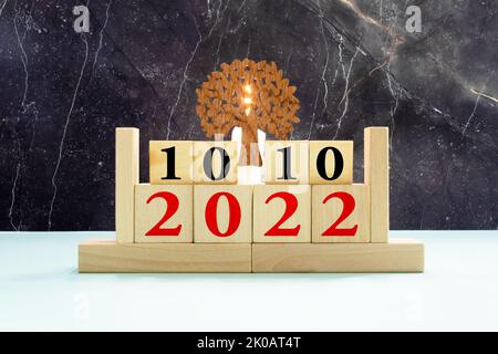 Male hand puts a block with the inscription 'World Mental Health Day' on cubes with the date october 10. Wooden table. Beautiful white background, cop Stock Photo