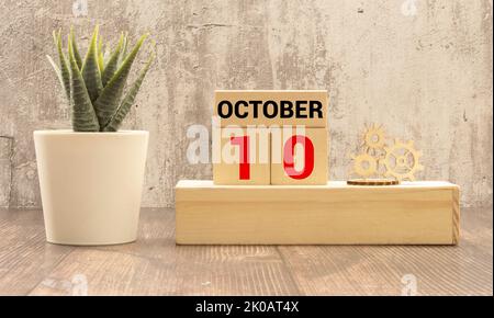 Male hand puts a block with the inscription 'World Mental Health Day' on cubes with the date october 10. Wooden table. Beautiful white background, cop Stock Photo