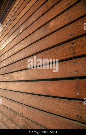 La Jolla, California- Horizontal wood planks wall exterior. Close-up of a building wall with natural smooth wood planks wall cladding. Stock Photo