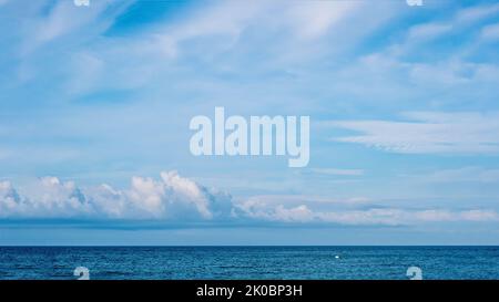 PANORAMA real photo natural cloudscape wallpaper. Beautiful white fluffy cumulus clouds summer blue sky calm sea horizon skyline. Concept relax mood Stock Photo