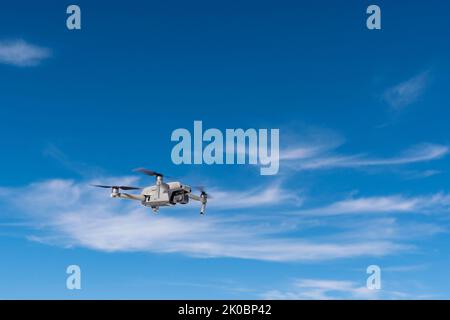 Drone in flight dynamics against the sky  Stock Photo