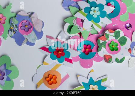 Full frame macro abstract texture design of colorful simple crafted paper flowers on a white background Stock Photo