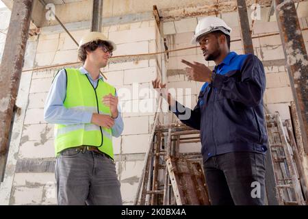 Architect and builder talking and inspector construction at construction site, contractor and worker discussion and planning strategy about progress i Stock Photo