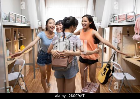 Young Chinese university student arriving at dormitory Stock Photo