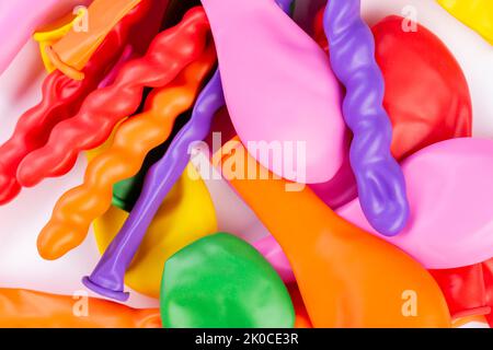 Сolorful deflated balloons. New colorful balloons. Object for birthday party decor. Top view. Stock Photo