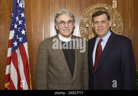 Secretary Mel Martinez with Reverend Luis Leon. Secretary Mel Martinez with Reverend Luis Leon Subject, Secretary Mel Martinez receiving visit at HUD Headquarters from Reverend Luis Leon, Rector of St. John's Episcopal Church, Washington, D.C. Stock Photo