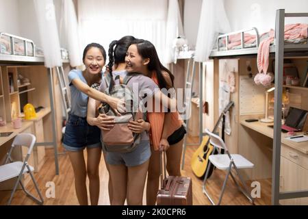 Young Chinese university student arriving at dormitory Stock Photo