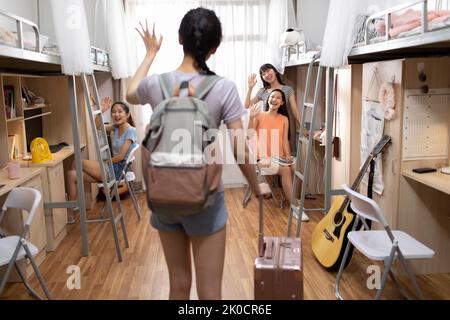 Young Chinese university student arriving at dormitory Stock Photo