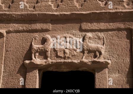 Close up two skilfully carved lion figures above tomb entrance Jabal At Banat Hegra Saudi Arabia Stock Photo