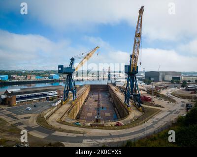 Aerial photo of a dry dock on Tyneside, River Tyne, with cranes. A&P Tyne Stock Photo